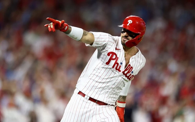 Nick Castellanos #8 of the Philadelphia Phillies celebrates after hitting asolo home run against the Atlanta Braves during the eighth inning in Game Three of the Division Series.