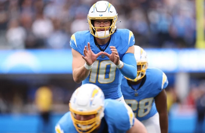 Justin Herbert #10 of the Los Angeles Chargers looks on at the line of scrimmage against the Las Vegas Raiders during the first half of the game at SoFi Stadium on October 01, 2023 in Inglewood, California.