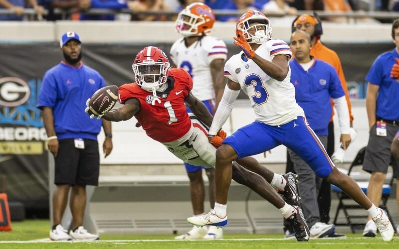 Marcus Rosemy-Jacksaint #1 of the Georgia Bulldogs attempts to catch a pass during the first half of a game against Jason Marshall Jr. #3 of the Florida Gators at TIAA Bank Field on October 29, 2022 in Jacksonville, Florida. The Georgia vs Florida Odds are warming up for this important game.