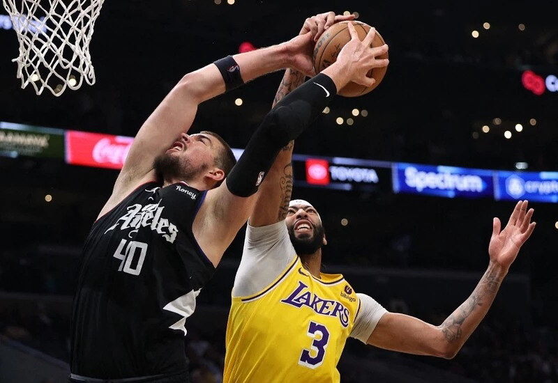 Ivica Zubac #40 of the LA Clippers and Anthony Davis #3 of the Los Angeles Lakers reach for a rebound during a 125-118 Clippers win at Crypto.com Arena on April 05, 2023 in Los Angeles, California. The Clippers vs Lakers Betting Odds are set for tonight's game.