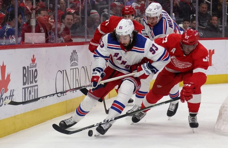 Mika Zibanejad #93 of the New York Rangers battles for the puck agaisnt David Perron #57 of the Detroit Red Wings during the second period at Little Caesars Arena on February 23, 2023 in Detroit, Michigan. The Red Wings vs Rangers Betting Odds are set.