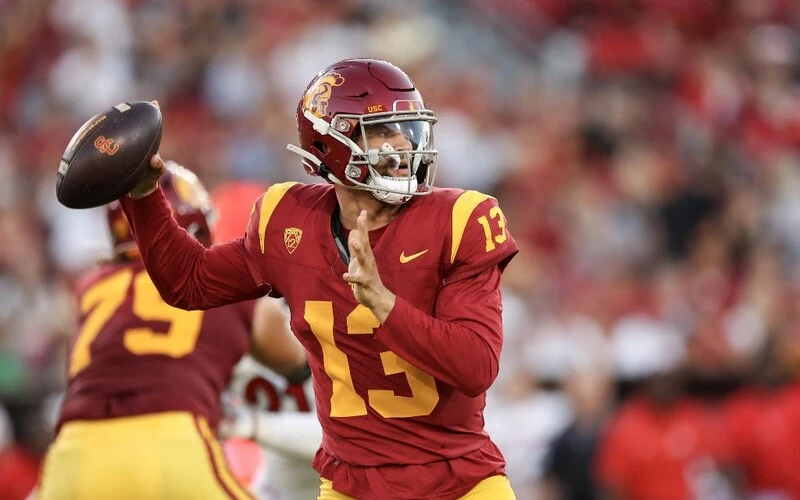 Caleb Williams #13 of the USC Trojans throws a pass in the first quarter against the Utah Utes at United Airlines Field at the Los Angeles Memorial Coliseum on October 21, 2023 in Los Angeles, California. The Washington vs USC Betting Odds are set.