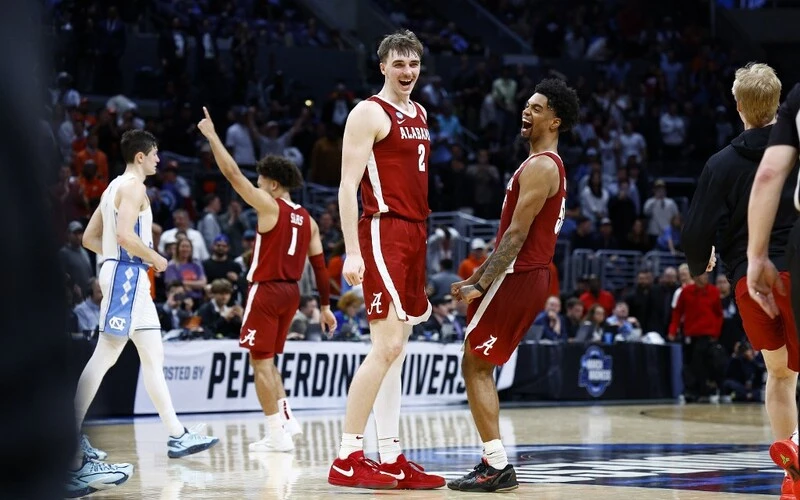 Clemson vs Alabama Prediction: Grant Nelson #2, Aaron Estrada #55 and Mark Sears #1of the Alabama Crimson Tide celebrate after defeating the North Carolina Tar Heels during the second half in the Sweet 16 round of the NCAA Men's Basketball Tournament at Crypto.com Arena on March 28, 2024 in Los Angeles, California. The Alabama Crimson Tide won, 89-87 Ronald Martinez/Getty Images/AFP