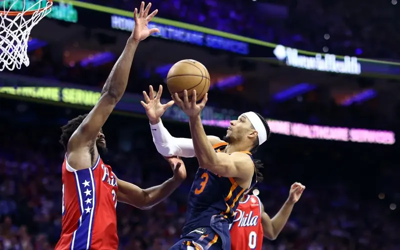 Josh Hart #3 of the New York Knicks shoots a lay up past Joel Embiid #21 of the Philadelphia 76ers during the third quarter of game four of the Eastern Conference First Round Playoffs at the Wells Fargo Center on April 28, 2024 in Philadelphia, Pennsylvania