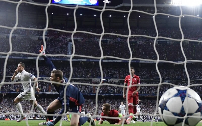 European Clasico Odds: Real Madrid's Portuguese forward Cristiano Ronaldo (L) celebrates a goal past Bayern Munich goalkeeper Manuel Neuer (2ndL) during the UEFA Champions League quarter-final second leg football match Real Madrid vs FC Bayern Munich at the Santiago Bernabeu stadium in Madrid in Madrid on April 18, 2017. Bayern Munich will receive Real Madrid for their UEFA Champions League semi final first leg on April 30, 2024 at the Allianz Arena in Munich, southern Germany. JAVIER SORIANO / AFP
