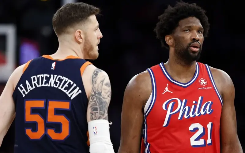 Joel Embiid #21 of the Philadelphia 76ers looks on against Isaiah Hartenstein #55 of the New York Knicks during the game in Game Two of the Eastern Conference First Round Playoffs at Madison Square Garden on April 22, 2024 in New York City. The Knicks won 104-101