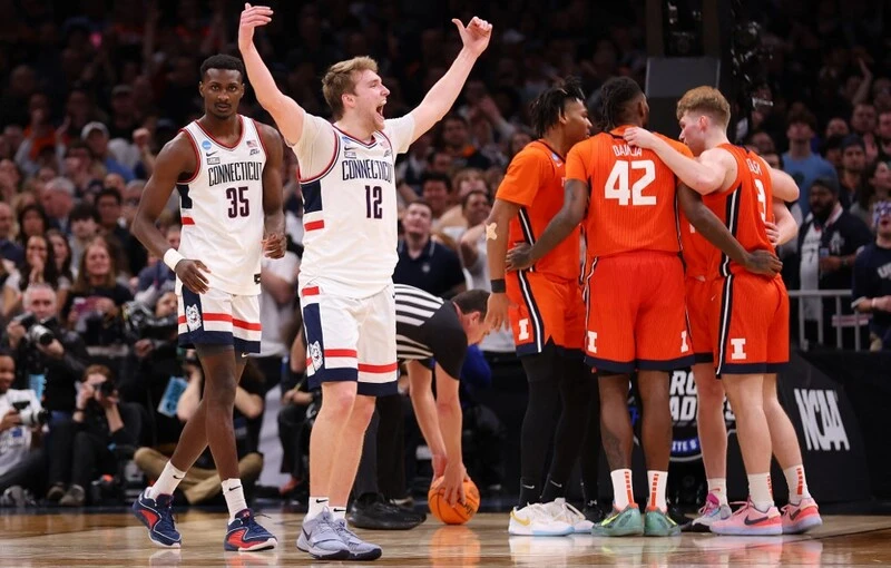 Alabama vs UConn Odds: Cam Spencer #12 of the Connecticut Huskies celebrates against the Illinois Fighting Illini during the second half in the Elite 8 round of the NCAA Men's Basketball Tournament at TD Garden on March 30, 2024 in Boston, Massachusetts. Michael Reaves/Getty Images/AFP