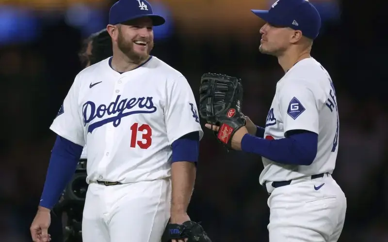 Max Muncy #13 of the Los Angeles Dodgers and Enrique Hernández #8 laugh after an 8-2 win over the Miami Marlins at Dodger Stadium on May 07, 2024 in Los Angeles, California.